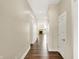 Hallway with hardwood floors, neutral paint, and views of the living room with stone fireplace at 2199 Somerset Dr, Franklin, IN 46131