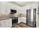 Well-equipped kitchen featuring stainless steel appliances, white cabinets, and stylish herringbone backsplash at 2199 Somerset Dr, Franklin, IN 46131
