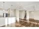 Bright, open-concept living room with hardwood floors and white trim, adjacent to a modern kitchen space at 2199 Somerset Dr, Franklin, IN 46131