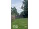 A fenced in backyard featuring a lush lawn, mature trees and a relaxing atmosphere at 245 E Plum St, Anderson, IN 46012