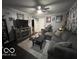 Inviting living room with dark floors, plush seating, and a cozy fireplace at 245 E Plum St, Anderson, IN 46012