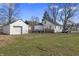 A spacious backyard features a detached garage and ample green space for outdoor activities, with a truck parked nearby at 3014 Alice Ave, Indianapolis, IN 46237