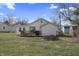 Image of the back of a single-story home with a quaint wooden deck and slider access at 3018 Alice Ave, Indianapolis, IN 46237