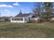 Back view showing an inviting single-story home with deck and a large yard at 3018 Alice Ave, Indianapolis, IN 46237