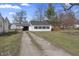 Charming single-story home with a spacious yard, garage, and a quaint wooden deck at 3018 Alice Ave, Indianapolis, IN 46237