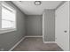 A cozy bedroom featuring a neutral color scheme, a window for natural light, and a closet for storage at 3022 Alice Ave, Indianapolis, IN 46237