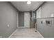 A well-lit utility room with light wood-look flooring, gray walls, and essential hookups at 3022 Alice Ave, Indianapolis, IN 46237