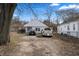 Cozy single-story home with a front yard, gravel driveway, and multiple cars parked out front at 3027 Alice Ave, Indianapolis, IN 46237