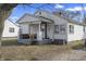 Cozy single-Gathering home featuring a covered front porch with outdoor seating and a tidy, traditional design at 3039 Alice Ave, Indianapolis, IN 46237