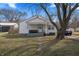 Charming single-story home featuring a welcoming front porch, mature trees, and a well-maintained lawn at 3039 Alice Ave, Indianapolis, IN 46237