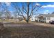 Residential property with a large bare yard, a mature tree, and views of the surrounding neighborhood at 3039 Alice Ave, Indianapolis, IN 46237