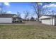 Large backyard with a detached garage and patio area, ideal for relaxation and outdoor entertainment at 3104 Alice Ave, Indianapolis, IN 46237