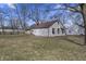 Spacious backyard with lawn featuring a home with white siding and a brown roof, perfect for outdoor activities at 3104 Alice Ave, Indianapolis, IN 46237