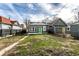 View of the back of the house with green and yellow doors, and a grassy yard at 3732 N Kenwood Ave, Indianapolis, IN 46208