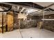 Unfinished basement with exposed brick walls, concrete floor, and utilities at 3732 N Kenwood Ave, Indianapolis, IN 46208