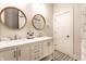 Bathroom showcasing a double vanity with marble countertops, modern faucets, and decorative mirrors at 3732 N Kenwood Ave, Indianapolis, IN 46208