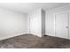 Bedroom featuring plush carpet, neutral walls, closet, and a simple white door with modern trim at 3732 N Kenwood Ave, Indianapolis, IN 46208