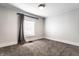 A bright, carpeted bedroom with neutral walls, a window with blinds, and simple, modern lighting fixture at 3732 N Kenwood Ave, Indianapolis, IN 46208