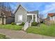 Charming gray home with a well-manicured lawn and inviting front porch with white railings at 3732 N Kenwood Ave, Indianapolis, IN 46208