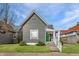 Inviting gray home showcasing a well-kept lawn and a bright green front door at 3732 N Kenwood Ave, Indianapolis, IN 46208