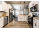Bright kitchen features stainless steel appliances, white cabinets and butcher block countertops at 3732 N Kenwood Ave, Indianapolis, IN 46208