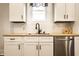 Close-up of the sink, dishwasher, white shaker cabinets, and butcher block countertops in the kitchen at 3732 N Kenwood Ave, Indianapolis, IN 46208