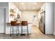 Bright eat-in kitchen features stainless steel appliances, breakfast bar and modern pendant lighting at 3732 N Kenwood Ave, Indianapolis, IN 46208