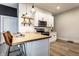 Open kitchen with white cabinets, butcher block countertops, stainless appliances and geometric backsplash at 3732 N Kenwood Ave, Indianapolis, IN 46208