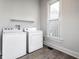 Bright laundry room featuring a washer, dryer, window, and overhead shelf at 3732 N Kenwood Ave, Indianapolis, IN 46208