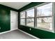 View of a sunroom with three large windows and a door with an outdoor view at 3732 N Kenwood Ave, Indianapolis, IN 46208
