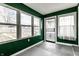 Green sunroom with large windows providing ample natural light and views of the outdoors at 3732 N Kenwood Ave, Indianapolis, IN 46208
