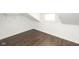 Unfinished attic space with a small window and open storage at 415 Ruskin Pl, Indianapolis, IN 46205