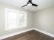 Bright bedroom featuring hardwood floors, neutral paint and a large window with white trim at 415 Ruskin Pl, Indianapolis, IN 46205