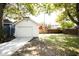 Exterior shot of a detached garage with a concrete driveway and grassy yard at 415 Ruskin Pl, Indianapolis, IN 46205