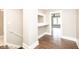 Hallway with hardwood floors, a built-in alcove, and stairs at 415 Ruskin Pl, Indianapolis, IN 46205