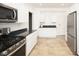 Stylish kitchen featuring sleek countertops, stainless steel appliances, and contemporary white cabinetry at 415 Ruskin Pl, Indianapolis, IN 46205