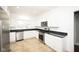 Modern kitchen featuring white cabinets, granite countertops, and stainless steel appliances at 415 Ruskin Pl, Indianapolis, IN 46205