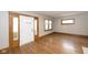 Bright living room with hardwood floors, natural light, and detailed wood trim around the doorway at 415 Ruskin Pl, Indianapolis, IN 46205