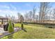 Scenic backyard with lush grass, decorative trees, and an outdoor grill area at 4179 Ironclad Dr, Bargersville, IN 46106