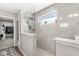Elegant walk-in shower with tiled walls, glass partition, and convenient shelving at 4179 Ironclad Dr, Bargersville, IN 46106