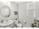 Cozy half bathroom with a pedestal sink, window, and neutral color scheme at 4179 Ironclad Dr, Bargersville, IN 46106