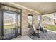 Inviting front porch with brick facade, rocking chairs, and charming curb appeal at 4179 Ironclad Dr, Bargersville, IN 46106