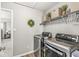 Well-organized laundry room with modern washer and dryer, storage shelves, and stylish accents at 4179 Ironclad Dr, Bargersville, IN 46106