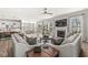 Open concept living room flows into dining area, features wood floors, a fireplace, and lots of natural light at 4179 Ironclad Dr, Bargersville, IN 46106