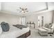 Bright main bedroom with tray ceiling, plush carpeting, and comfortable seating area at 4179 Ironclad Dr, Bargersville, IN 46106