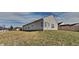 Backyard featuring a large grassy area, a wooden fence and the home's rear windows at 5467 Powder River Ct, Indianapolis, IN 46221