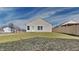 View of the backyard featuring a well-maintained lawn, new wooden fence and view of the home's rear elevation at 5467 Powder River Ct, Indianapolis, IN 46221