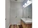 Bathroom featuring a modern vanity, large mirror, wooden accents and new fixtures at 5467 Powder River Ct, Indianapolis, IN 46221