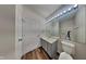 Well-maintained bathroom features modern fixtures and ample lighting, with wood look floors at 5467 Powder River Ct, Indianapolis, IN 46221