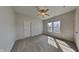 Comfortable bedroom with a ceiling fan, two bright windows and plush carpeting at 5467 Powder River Ct, Indianapolis, IN 46221